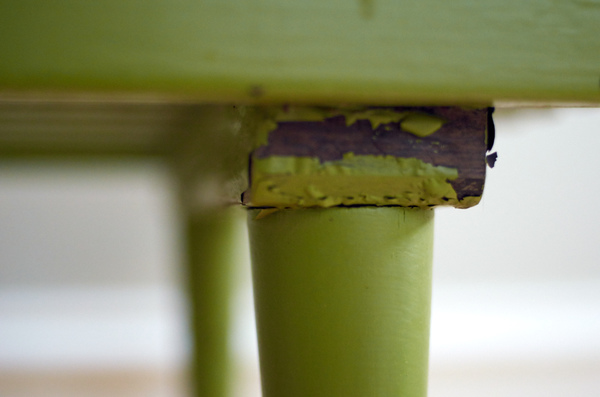 Peeling paint underneath a vintage bench