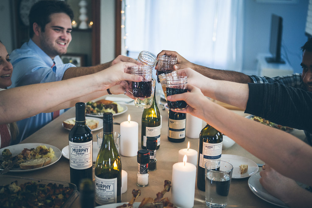 Toasting with wine at a friends Thanksgiving (Friendsgiving) celebration