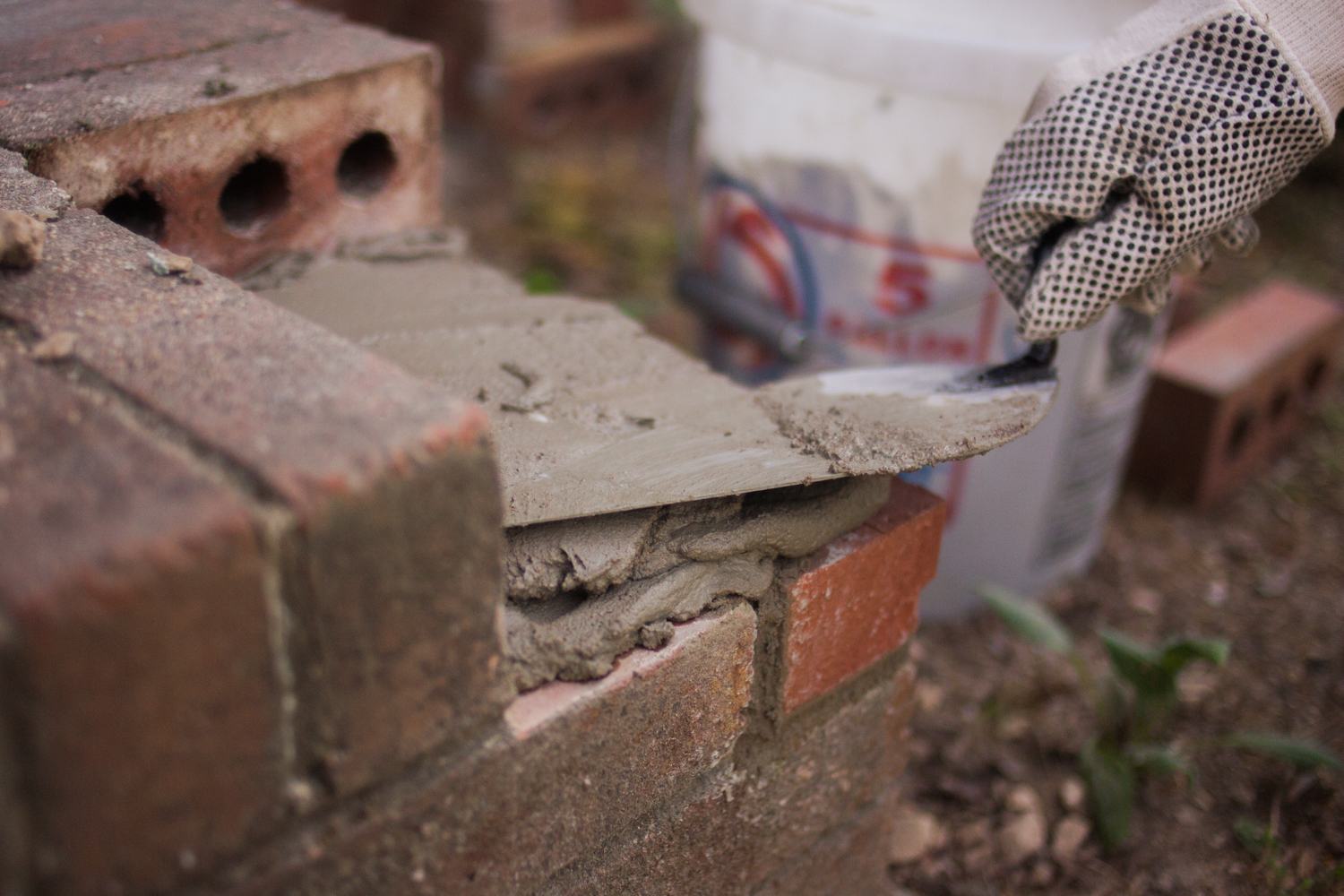 applying mortar to bricks