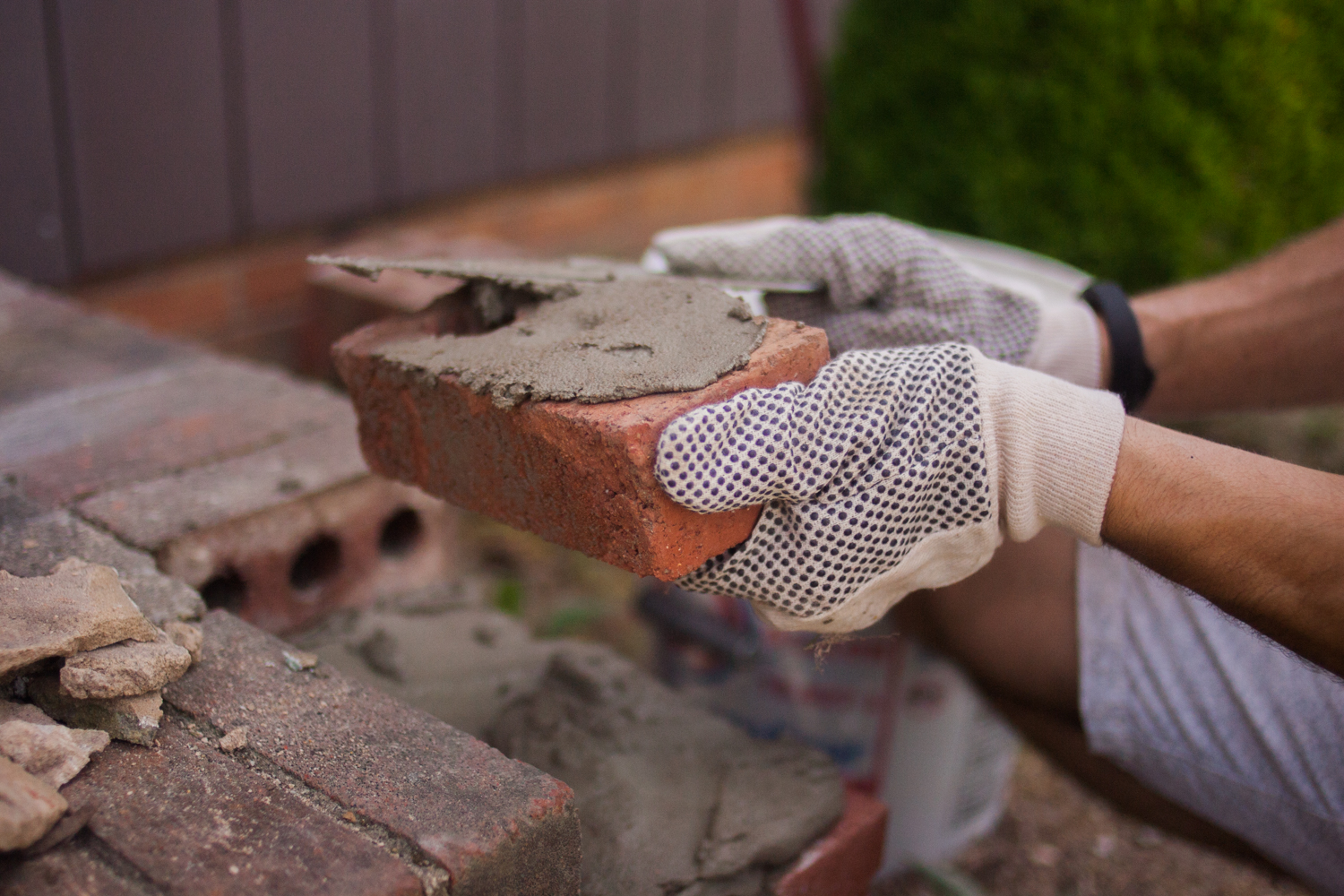 spreading mortar onto bricks