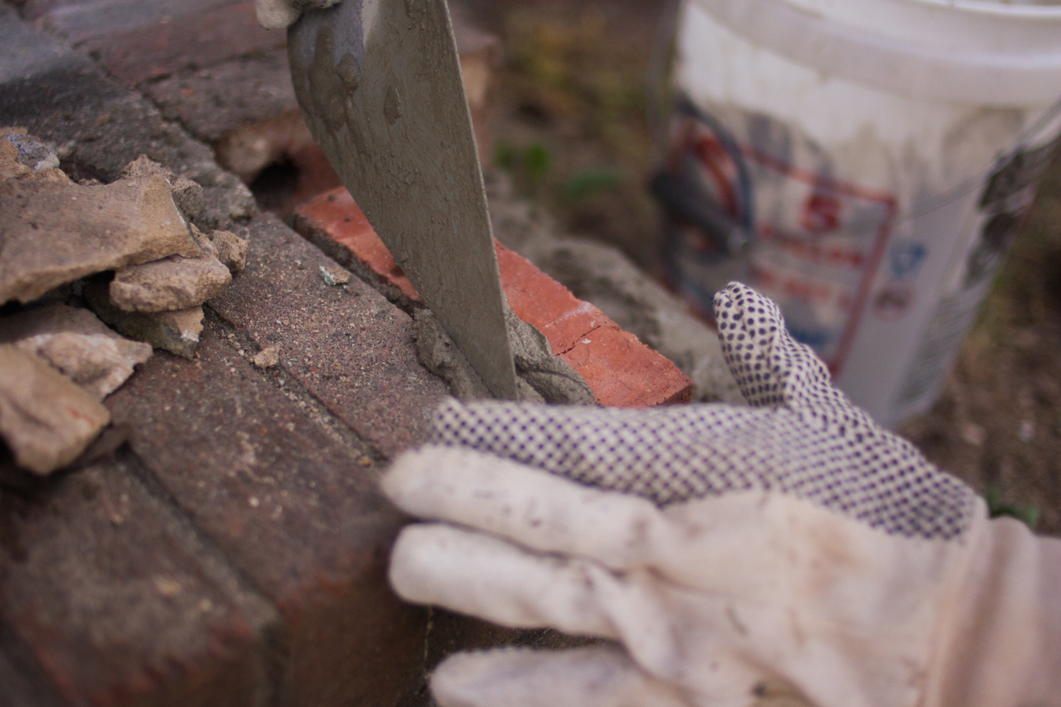 wiping excess mortar from in-between bricks