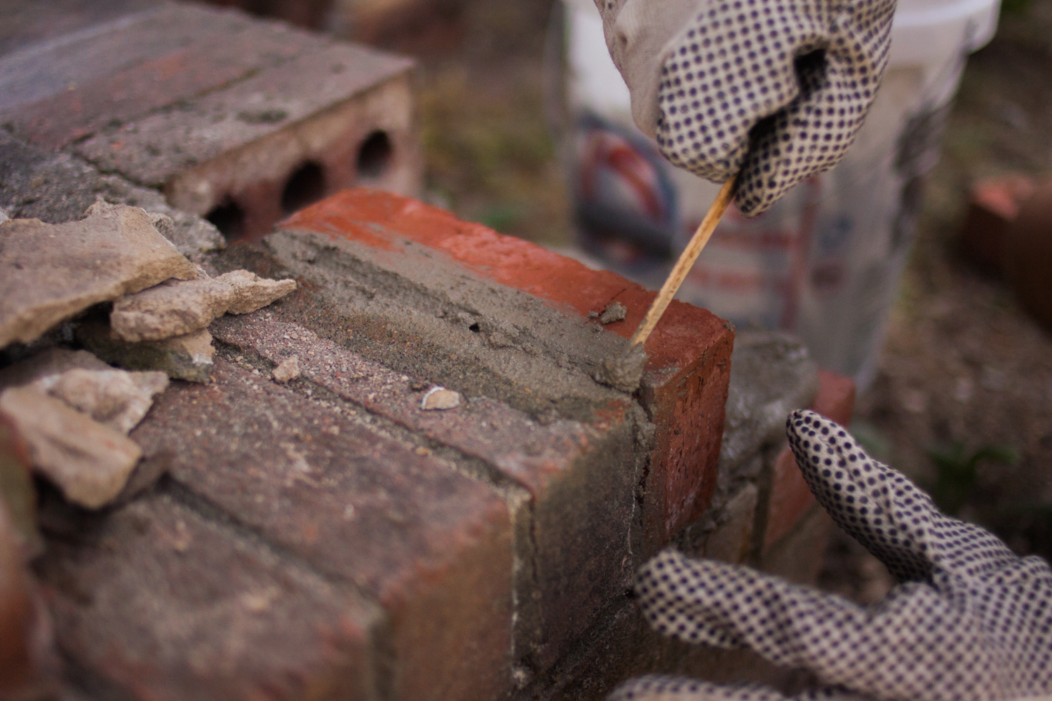 smoothing out excess mortar from bricks