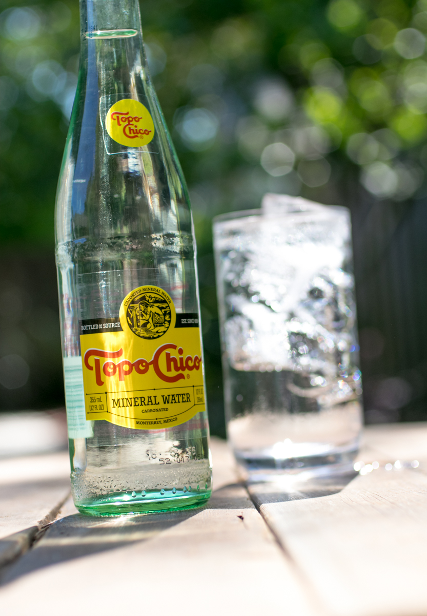 Topo Chico bottle sparkling water in outdoor setting