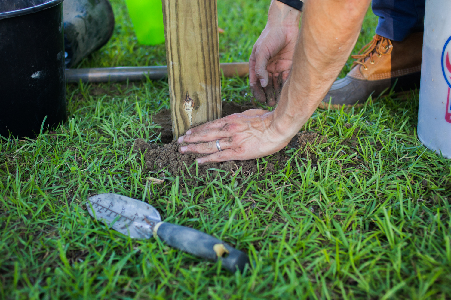 setting a clothesline post into the ground