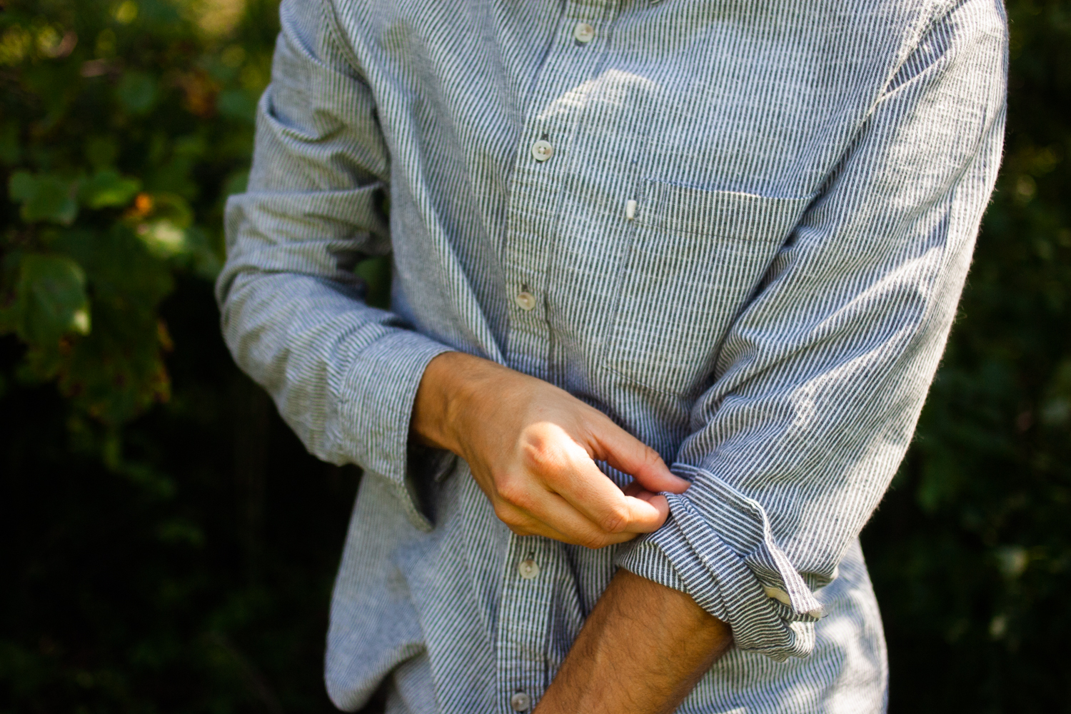 men's shirt sleeves rolled up